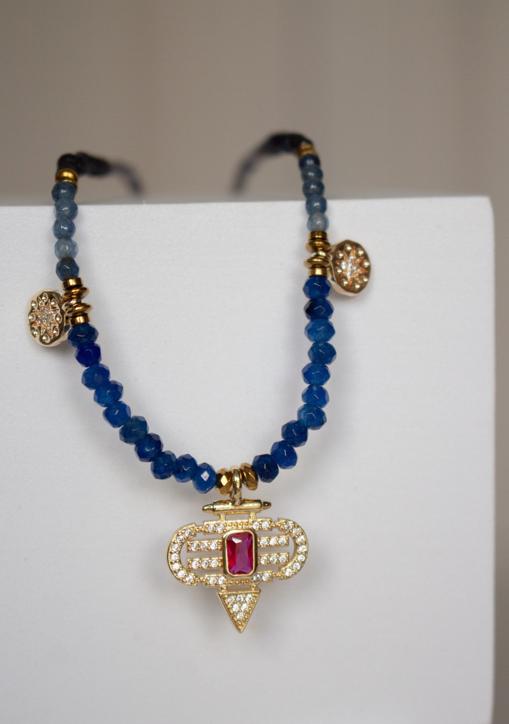 Blue Rondelle Necklace with Red Aztec Pendant