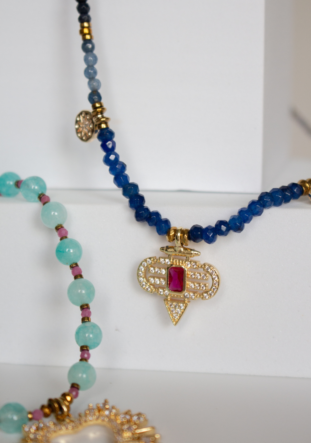 Blue Rondelle Necklace with Red Aztec Pendant